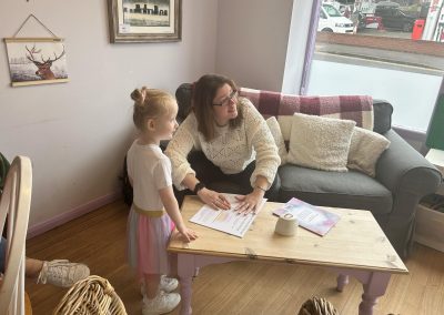Leah signing a book for a very happy little girl