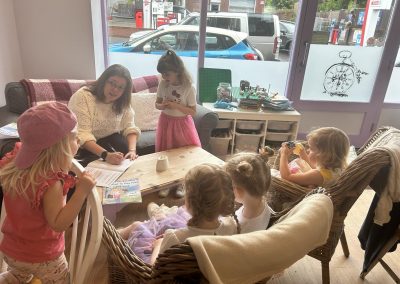Leah reading her book the princess who wanted to play hide and seek. To a group of young children aged about 3-6 years old. they are all sitting listening intently.